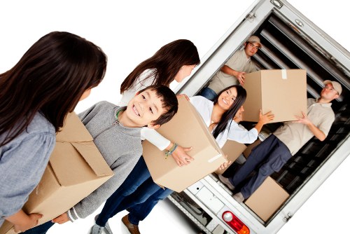 Moving boxes and furniture during a Brompton removals job in a city setting