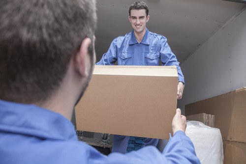 Professional house removals team managing boxes in Brompton