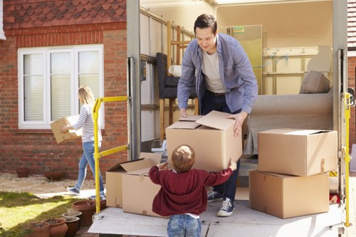 Removal team handling furniture in a Brompton residential property