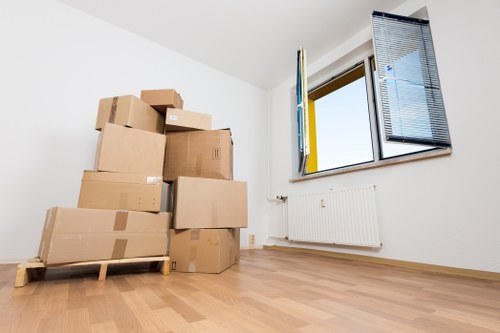 Moving team handling packed household items during a removal service