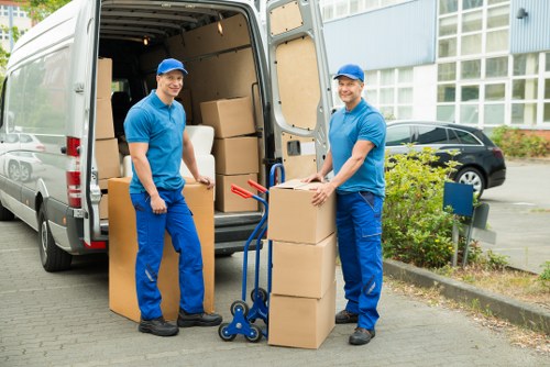 Professional movers loading furniture into a moving truck in Brompton